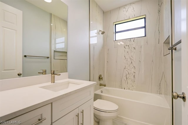 full bathroom featuring tiled shower / bath, toilet, and large vanity