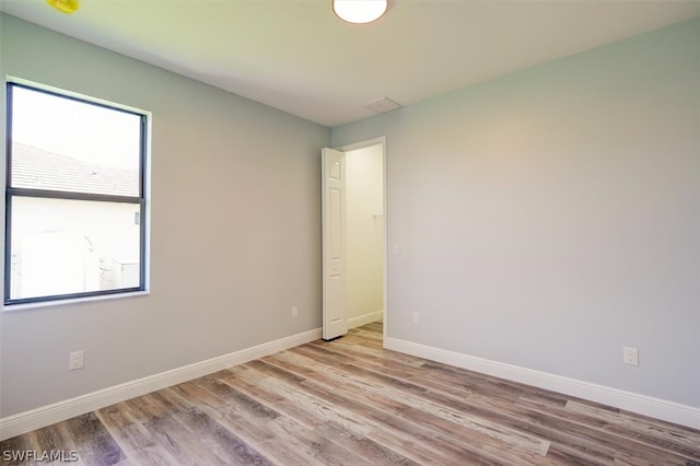 empty room with hardwood / wood-style flooring