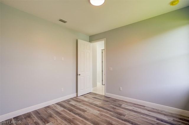 unfurnished room featuring wood-type flooring