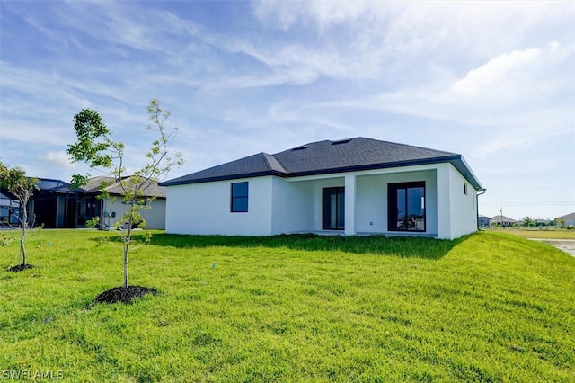 back of house featuring a yard