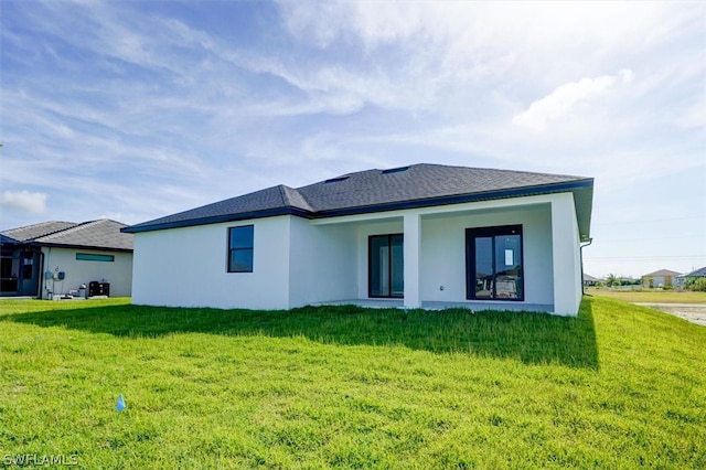 rear view of property with a yard