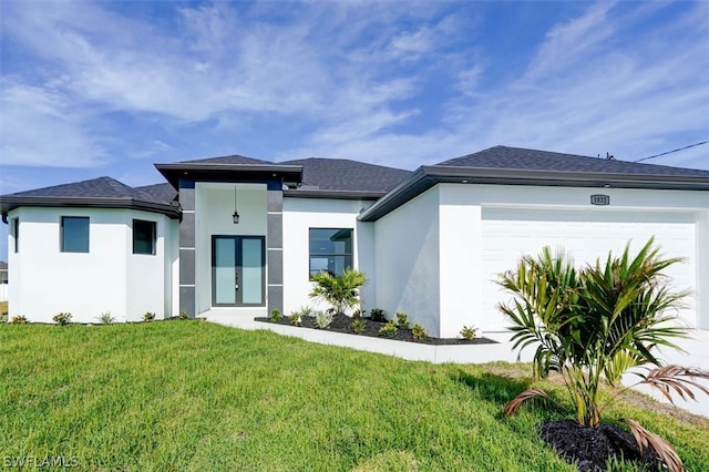 prairie-style home with a garage and a front lawn