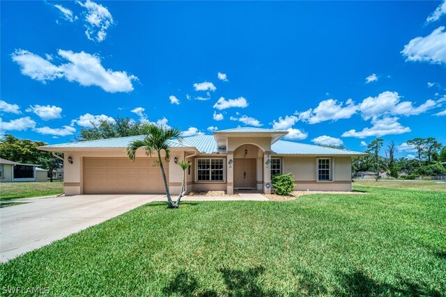 ranch-style home featuring a garage and a front lawn