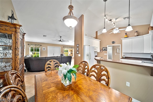 dining room with ceiling fan, sink, and light tile flooring