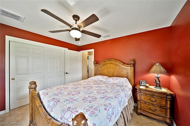 bedroom with tile flooring, a closet, and ceiling fan