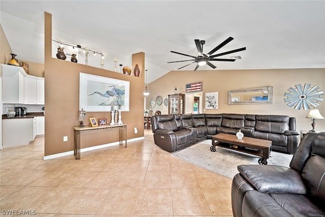 living room with rail lighting, lofted ceiling, ceiling fan, and light tile flooring