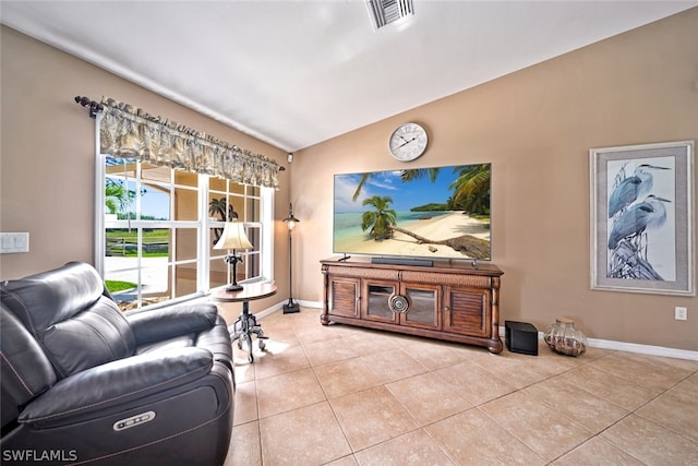 living room with vaulted ceiling and light tile floors