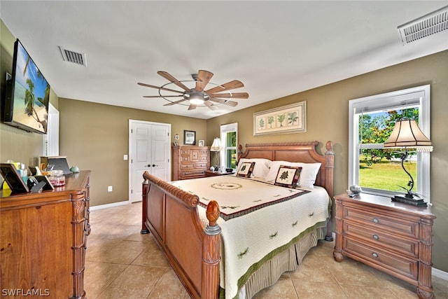 bedroom with ceiling fan and light tile floors