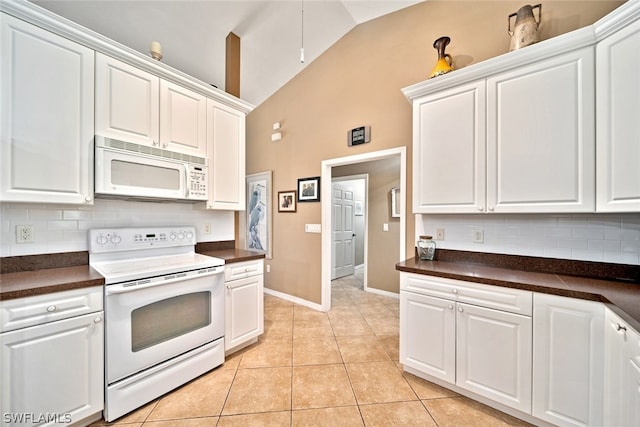 kitchen featuring white cabinetry, tasteful backsplash, and white appliances