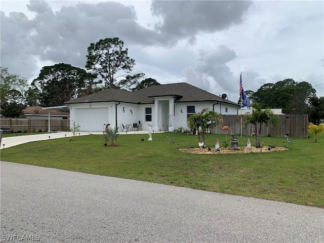 view of front facade with a front yard and a garage