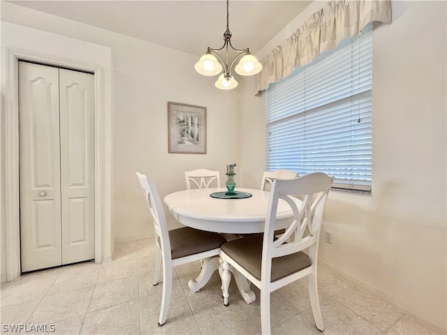 dining space with light tile flooring and an inviting chandelier