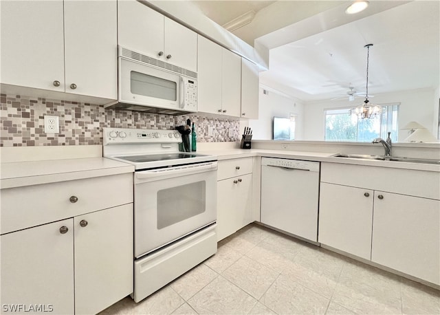 kitchen with white cabinetry, tasteful backsplash, white appliances, and sink