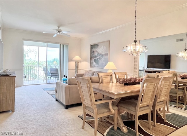 dining room with ceiling fan with notable chandelier, crown molding, and carpet floors