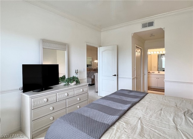 bedroom with crown molding, light colored carpet, and connected bathroom