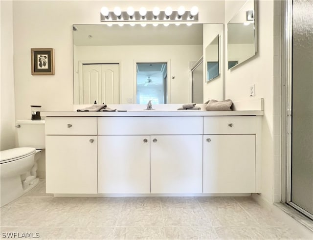 bathroom with an enclosed shower, toilet, tile flooring, and vanity