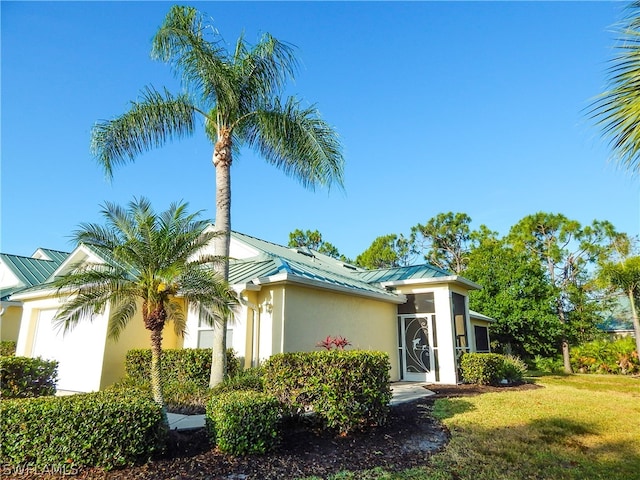 view of property exterior with a lawn