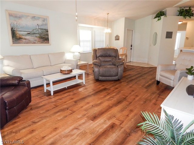 living room with an inviting chandelier and hardwood / wood-style floors