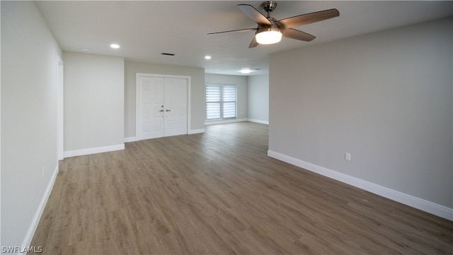 empty room with wood-type flooring and ceiling fan