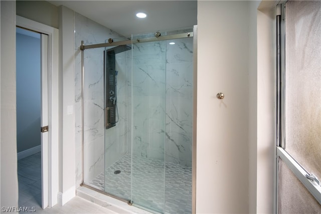 bathroom featuring hardwood / wood-style flooring and an enclosed shower