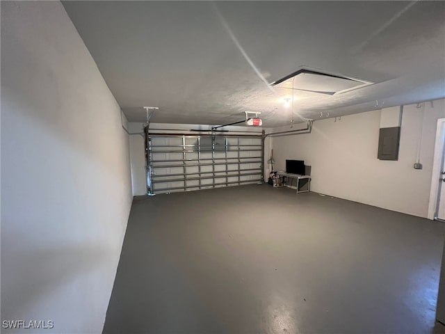 garage with a garage door opener and electric panel