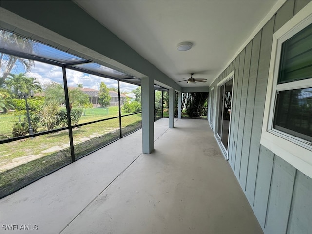 unfurnished sunroom featuring ceiling fan