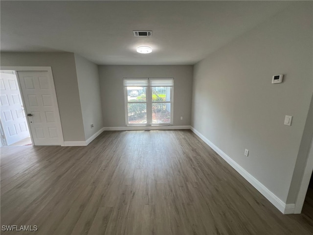 unfurnished room featuring dark hardwood / wood-style floors