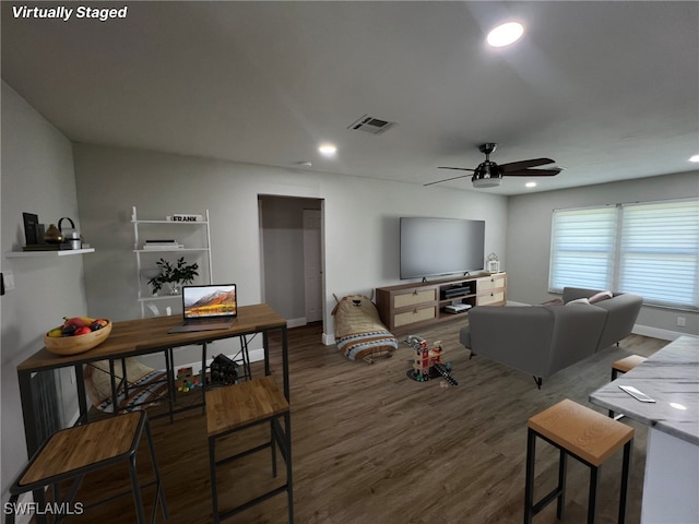 living room with ceiling fan and dark hardwood / wood-style flooring