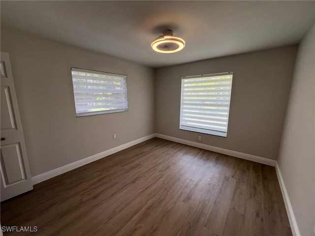 empty room with dark wood-type flooring