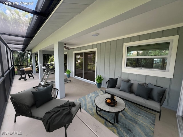 view of patio / terrace featuring glass enclosure, ceiling fan, and outdoor lounge area