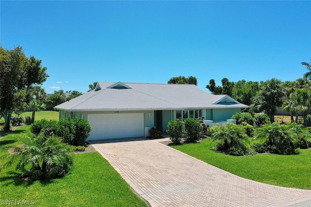 ranch-style house with a garage and a front yard