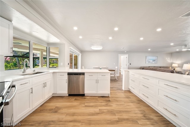 kitchen featuring kitchen peninsula, white cabinetry, dishwasher, range, and light wood-type flooring