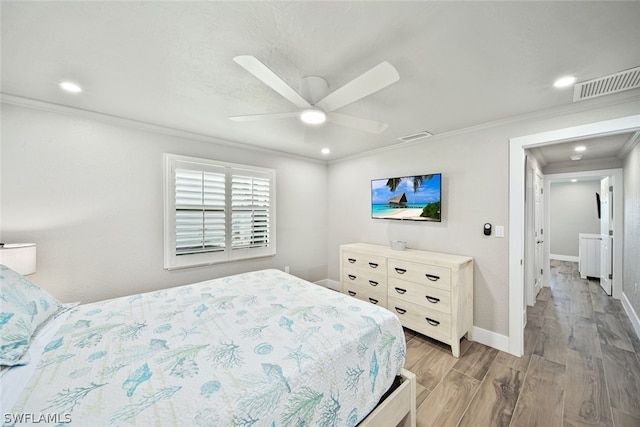 bedroom featuring ceiling fan, crown molding, and hardwood / wood-style flooring