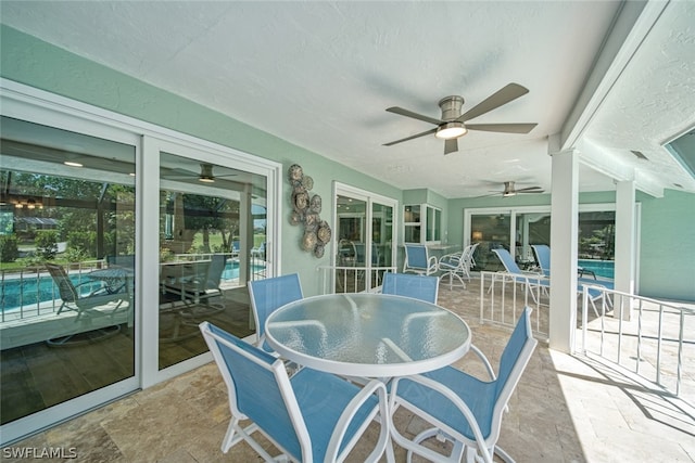 sunroom featuring ceiling fan