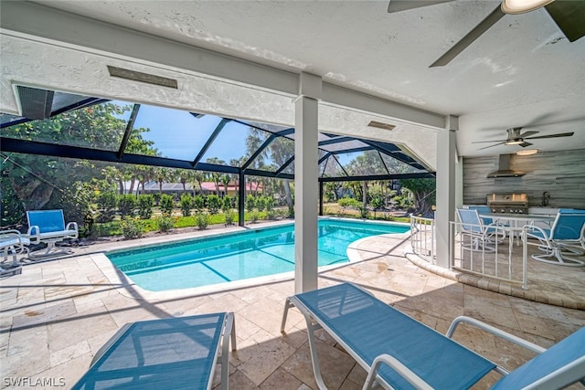 view of pool featuring sink, ceiling fan, a patio area, and glass enclosure