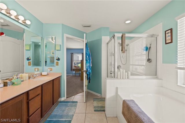 bathroom with independent shower and bath, vanity, and tile floors