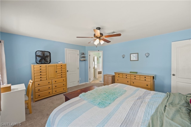 bedroom with connected bathroom, ceiling fan, and carpet floors