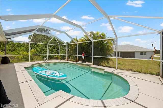 view of swimming pool featuring a lanai and a yard