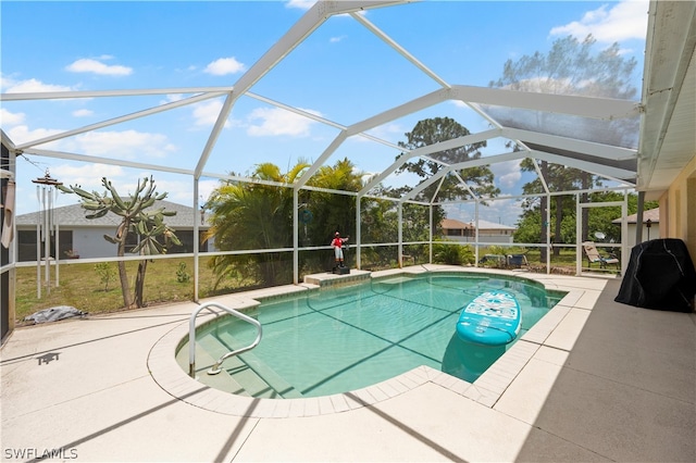 view of swimming pool featuring a lanai and a patio