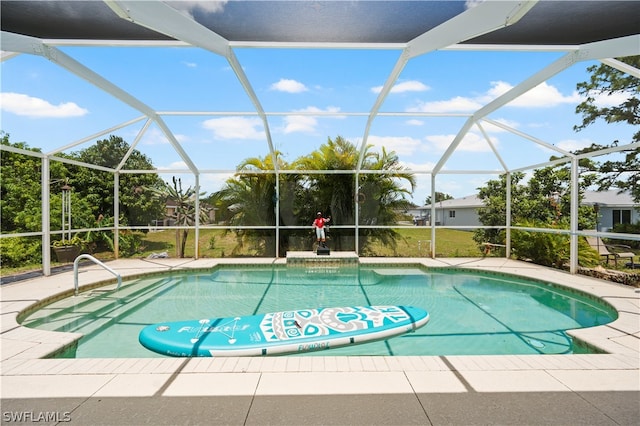 view of swimming pool with glass enclosure