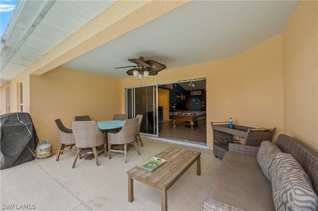 view of patio with an outdoor living space, a grill, and ceiling fan