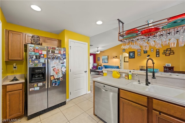 kitchen featuring ceiling fan, sink, stainless steel appliances, and light tile floors