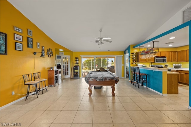 recreation room with ceiling fan, billiards, vaulted ceiling, and light tile flooring