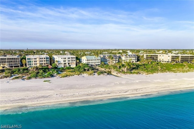 birds eye view of property featuring a view of the beach and a water view