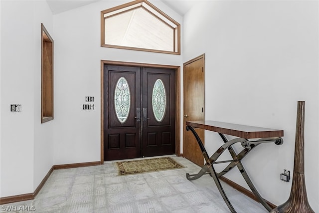 entryway with plenty of natural light and high vaulted ceiling