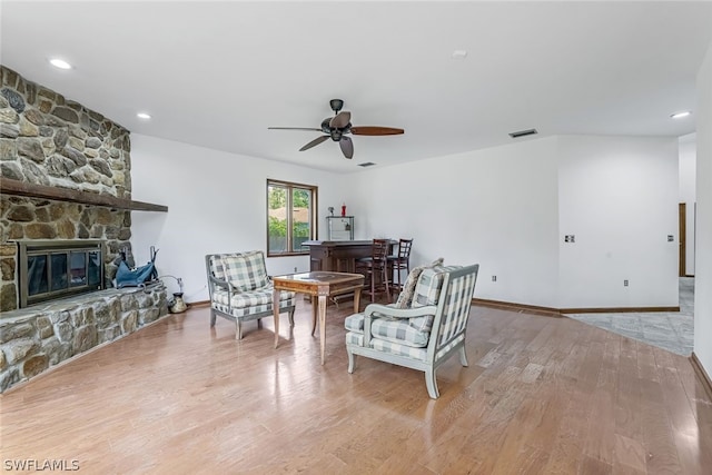 interior space with ceiling fan, a fireplace, and light wood-type flooring