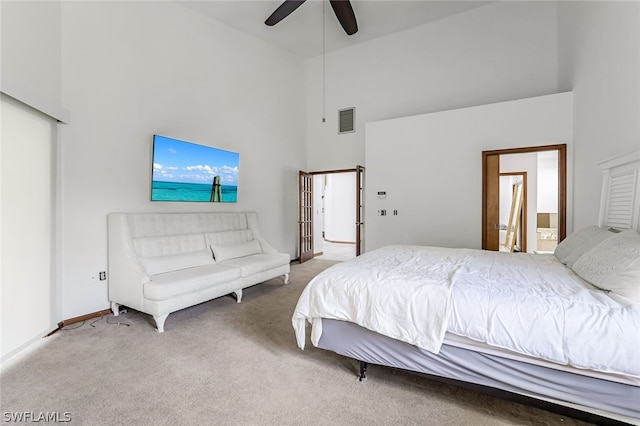 bedroom with a towering ceiling, carpet flooring, and ceiling fan