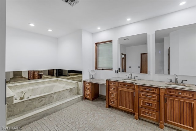 bathroom featuring a bath, tile flooring, and dual bowl vanity