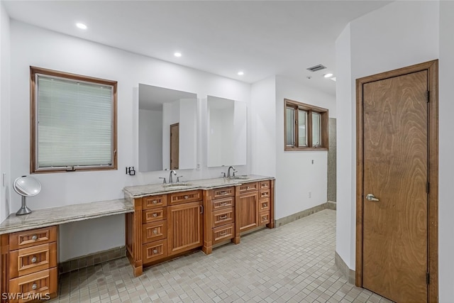 bathroom with tile flooring, large vanity, and double sink