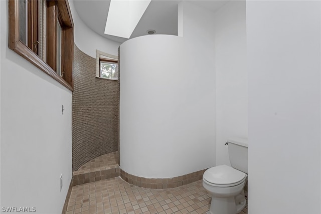 bathroom with tile floors and toilet