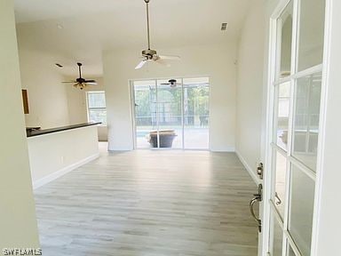 interior space with light hardwood / wood-style floors and ceiling fan